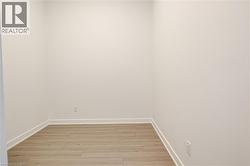 Unfurnished room featuring light wood-style flooring and baseboards - 