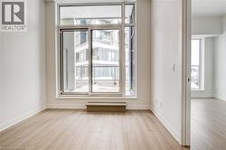 Empty room with light wood-style flooring and baseboards - 