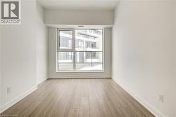 Empty room with light wood-style floors and baseboards - 