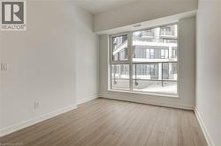 Unfurnished room featuring light wood-style floors and baseboards - 