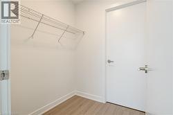 Spacious closet with light wood-type flooring - 