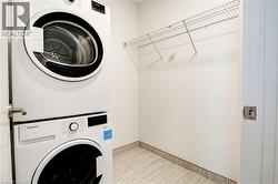 Laundry area featuring stacked washing machine and dryer - 