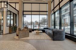 Community lobby with a towering ceiling and a wall of windows - 