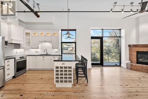 114 - 83 Little Bridge Street, Mississippi Mills, ON - Indoor Photo Showing Kitchen With Fireplace