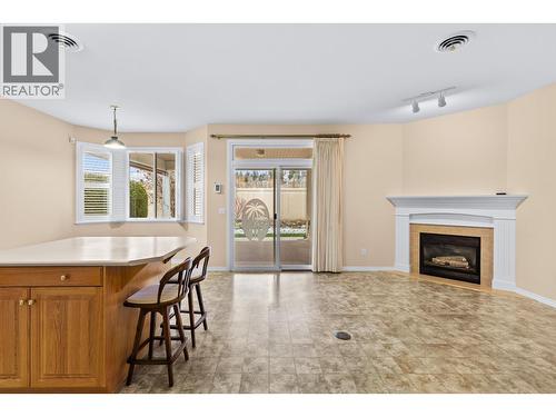 Eat in kitchen with lino floors and fireplace - 3360 Old Okanagan Highway Unit# 160, West Kelowna, BC - Indoor Photo Showing Living Room With Fireplace