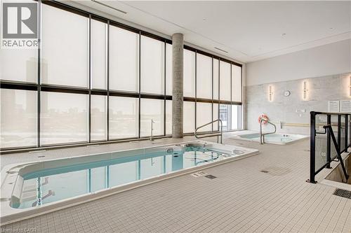 View of swimming pool featuring a sunroom - 25 Wellington Street A S Unit# 209, Kitchener, ON - Indoor Photo Showing Other Room