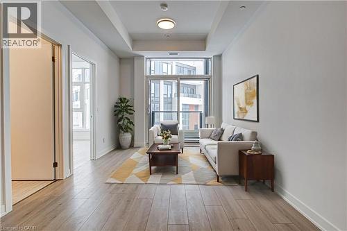 Living room with light wood finished floors and a raised ceiling - 25 Wellington Street A S Unit# 209, Kitchener, ON - Indoor