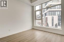 Empty room with baseboards and light wood-style flooring - 