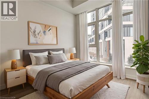 Bedroom with wood finished floors and baseboards - 25 Wellington Street A S Unit# 209, Kitchener, ON - Indoor Photo Showing Bedroom
