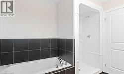 Bathroom featuring a bath and a shower stall - 