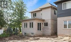 Rear view of house featuring brick siding - 