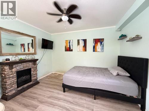 580 Cameron Avenue, Grand Forks, BC - Indoor Photo Showing Bedroom With Fireplace