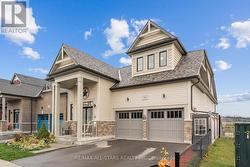 Paved driveway, covered entry, double garage - 