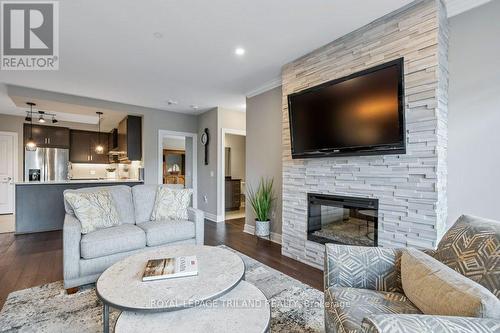 504 - 1200 Commissioners Road W, London South (South B), ON - Indoor Photo Showing Living Room With Fireplace