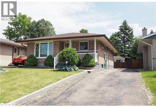 Ranch-style house featuring a front yard, a porch, brick siding, and driveway - 86 Overlea Crescent Unit# Main, Waterloo, ON - Outdoor With Facade