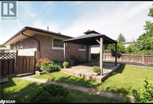 Rear view of property with a wooden deck, a fenced backyard, a gazebo, and brick siding - 86 Overlea Crescent Unit# Main, Waterloo, ON - Outdoor