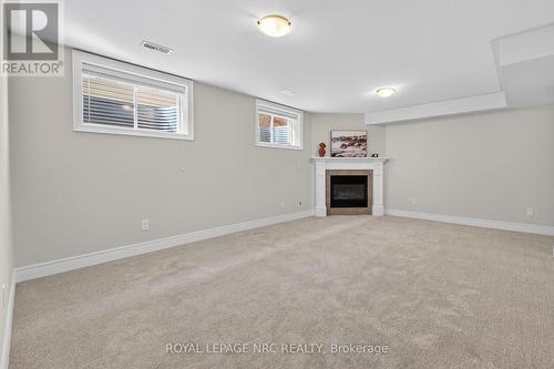 FAMILY ROOM (DOWN) HAS NEW CARPET - 56 Dominion Road, Fort Erie (Lakeshore), ON - Indoor With Fireplace