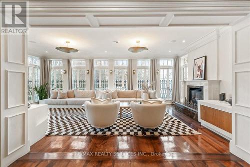 Sunroom wrapped in windows feat. a gas fireplace. - 574 Conservation Drive, Brampton, ON - Indoor Photo Showing Living Room With Fireplace