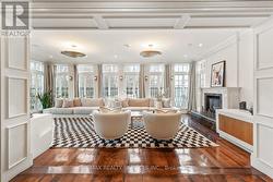 Sunroom wrapped in windows feat. a gas fireplace. - 