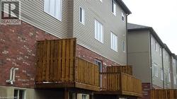 View of home's exterior featuring brick siding and a deck - 
