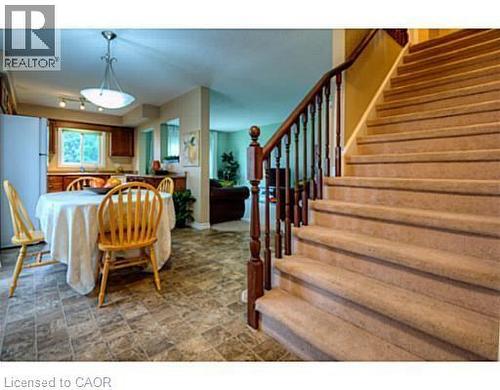 Dining space with stairs and stone finish floors - 87 Iron Gate Street, Kitchener, ON - Indoor Photo Showing Other Room