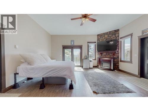 1370 Bullmoose Way, Osoyoos, BC - Indoor Photo Showing Bedroom With Fireplace