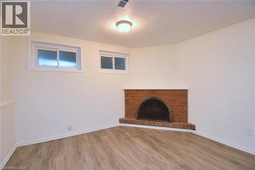 Unfurnished living room with a fireplace and light wood finished floors - 510 Cumberland Avenue, Burlington, ON - Indoor With Fireplace
