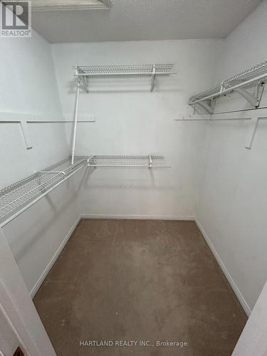Primary W/I Closet - 4 - 1160 Walden Circle, Mississauga, ON - Indoor With Storage