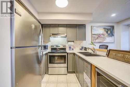 A206 - 15 Cornell Meadows Avenue, Markham, ON - Indoor Photo Showing Kitchen With Stainless Steel Kitchen With Double Sink With Upgraded Kitchen