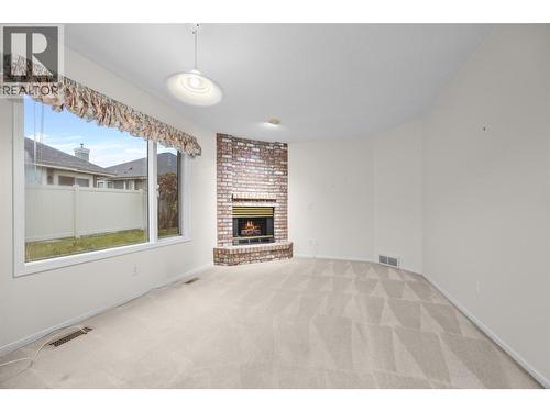 Family Room - 595 Yates Road Unit# 99, Kelowna, BC - Indoor With Fireplace