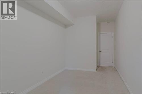 Unfurnished room featuring baseboards and light carpet - 25 Isherwood Avenue Unit# G105, Cambridge, ON - Indoor Photo Showing Other Room