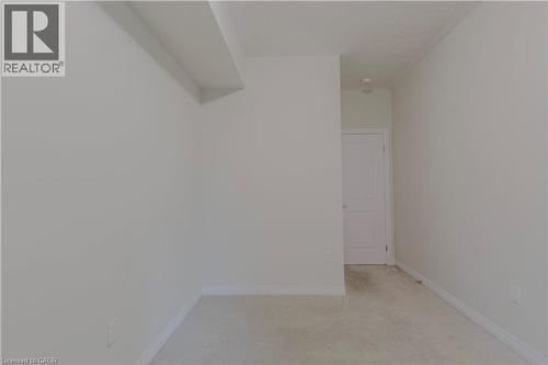 Empty room featuring baseboards and light carpet - 25 Isherwood Avenue Unit# G105, Cambridge, ON - Indoor Photo Showing Other Room