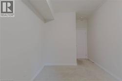 Empty room featuring baseboards and light carpet - 