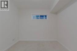 Spare room with light carpet and baseboards - 