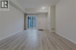 Spare room featuring baseboards and light wood-type flooring - 