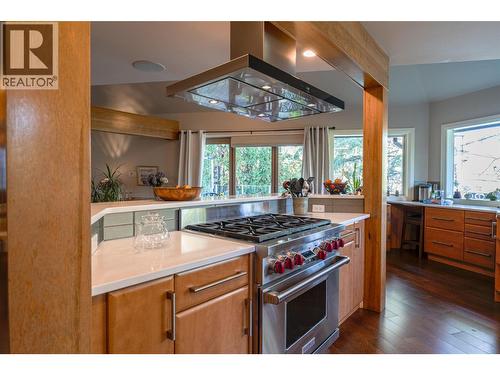 high capacity hood fan over 6 burner gas range - 14038 Ponderosa Way, Coldstream, BC - Indoor Photo Showing Kitchen