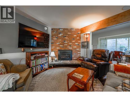 Sitting area off Kitchen with gas Fireplace - 14038 Ponderosa Way, Coldstream, BC - Indoor Photo Showing Living Room With Fireplace