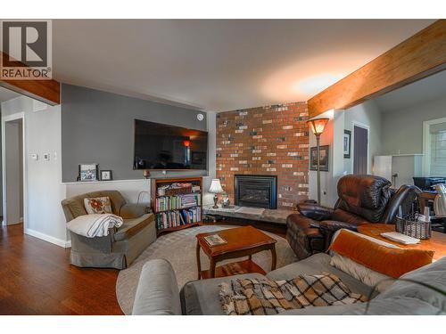 Sitting area off Kitchen with gas Fireplace - 14038 Ponderosa Way, Coldstream, BC - Indoor Photo Showing Living Room With Fireplace