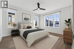 Bedroom with ceiling fan and wood finished floors - 