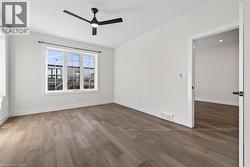 Empty room featuring wood finished floors and ceiling fan - 
