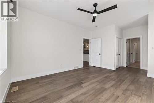 Unfurnished bedroom featuring wood finished floors and a ceiling fan - 7 South Court Street W, Norwich, ON - Indoor Photo Showing Other Room