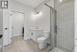 Full bath with vanity, a stall shower, and washer / dryer - 