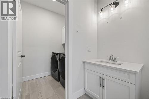 Bathroom featuring vanity and separate washer and dryer - 7 South Court Street W, Norwich, ON - Indoor Photo Showing Laundry Room