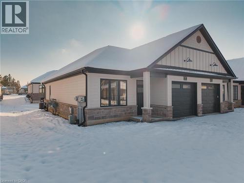 View of front facade with stone siding and an attached garage - 7 South Court Street W, Norwich, ON - Outdoor