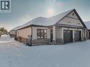 View of front facade with stone siding and an attached garage - 7 South Court Street W, Norwich, ON  - Outdoor 