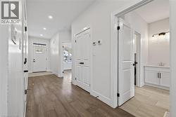 Corridor featuring light wood finished floors and recessed lighting - 
