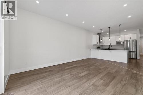 Unfurnished living room featuring recessed lighting and dark wood finished floors - 7 South Court Street W, Norwich, ON - Indoor Photo Showing Kitchen