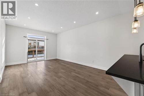 Unfurnished living room with dark wood finished floors, recessed lighting, and a textured ceiling - 7 South Court Street W, Norwich, ON - Indoor