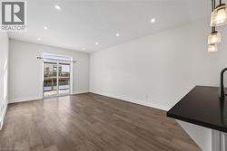 Unfurnished living room with dark wood finished floors, recessed lighting, and a textured ceiling - 
