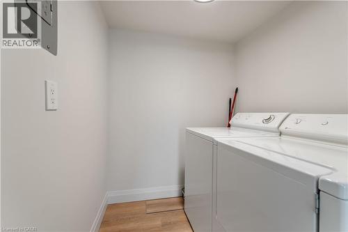 Washroom featuring washer and clothes dryer and light wood finished floors - 120 Duke Street Unit# 905, Hamilton, ON - Indoor Photo Showing Laundry Room